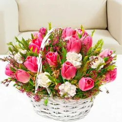 Canasta blanca hecha con tulipanes y claveles blancos.